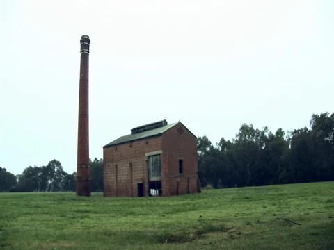Wide shot of an old abandoned building. Pan across the screen. Stock Footage 79905425