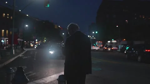 Wide Shot of Older Man Using Phone on Night Street Stock Footage 130485069