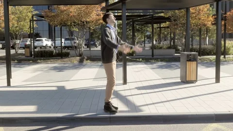 Wide shot of one man gesturing with frustration in autumn park, surreal style. Video stock 331820128