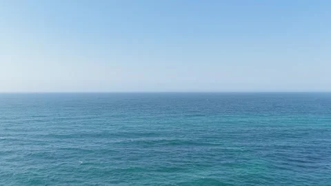 Wide shot of the open Atlantic Ocean under a clear blue sky, filmed from Praia Stock Footage 346691394