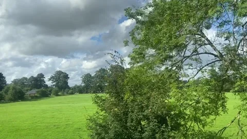 Wide shot out of a window of train, tracking along flat British UK southern uk 動画素材 166468952