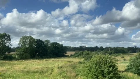 Wide shot out of a window of train, tracking along flat British UK southern uk Stock Footage 166469267