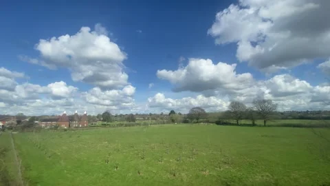 Wide shot out of a window of train, tracking along flat British UK southern  Stock Footage 271077485