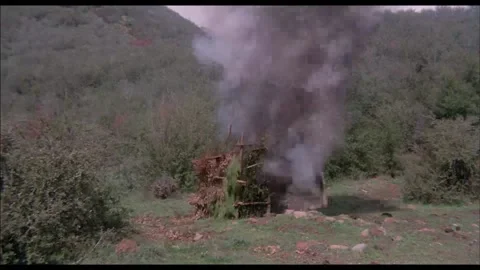 Wide shot of outhouse exploding in clearing in woods, 1970s Stock Footage 260259080