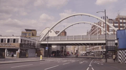 WIDE SHOT OF OVERGROUND TRAIN GOING OVER SHOREDITCH HIGH STREET Stock Footage 126664091