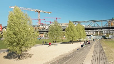 Wide shot: Park in Berlin during Coronavirus Lockdown, U-Bahn passes over bridge Stock Footage