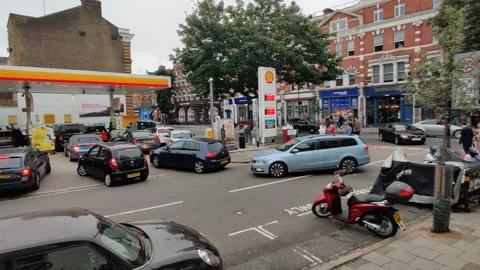 WIDE SHOT OF PETROL PUMP PACKED WITH CARS DURING PANIC BUYING 2021 4K UK Stock Footage 161576444