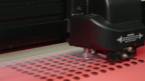 A wide shot of a plotter cutting out round stickers. Stock Footage 163085329