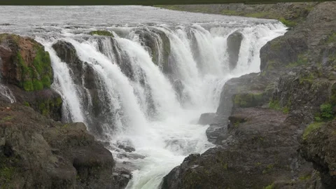 Wide Shot of a Powerful Waterfall Cascading Over Rocky Terrain in Iceland Stock Footage 339804554