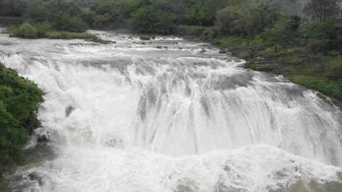 Wide shot of a powerful waterfall flowing through forest Video stock 333817347