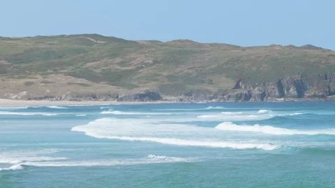 Wide shot of Praia do Rostro beach in Spain, showing turquoise waves rolling Stock Footage 346717000