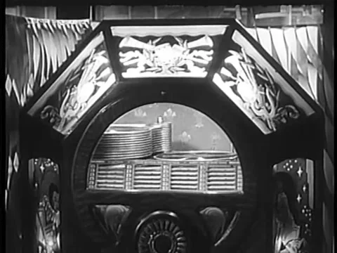 Wide shot of record dropping in jukebox, 1940s Stock Footage 64630118