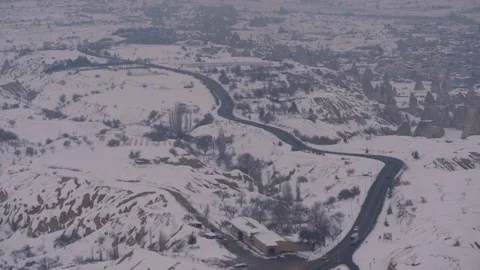A wide shot of a road passing through a snow covered landscape in turkey Stock Footage 311156380
