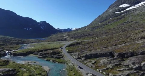 Wide Shot of Road Through Mountain On Sunny Day Stock Footage 83476780