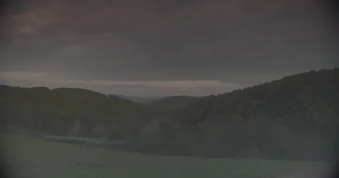 Wide Shot Rolling Green Hills And Dense Forest Cloudy Sunset Sky Poland Stock Footage 330173953
