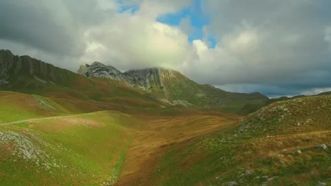 Wide shot of rolling hills and rocky mountains in Durmitor National Park 動画素材 342799722