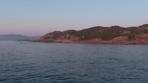 Wide shot of the rugged coastline near Baiona, Spain, captured during dusk. The Stock Footage 346708200