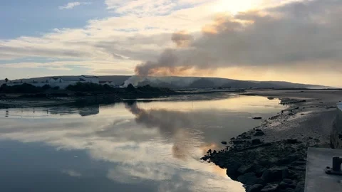 Wide Shot of Rural Field Fire with Distant City Stock Footage 321040352
