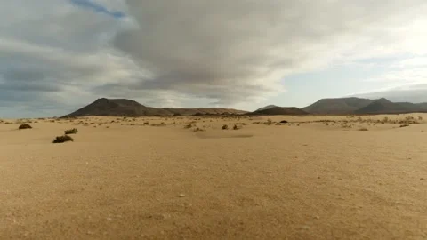 A wide shot of sand dunes with clouds Vídeo Stock 211390997