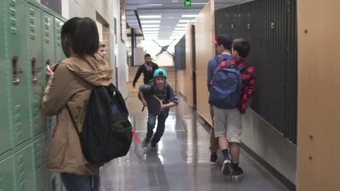 Wide shot of security person chasing young boy Stock Footage 73285424
