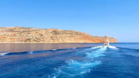 Wide shot of ship leaving traces on the water on a bright sunny day Stock Footage 159010146