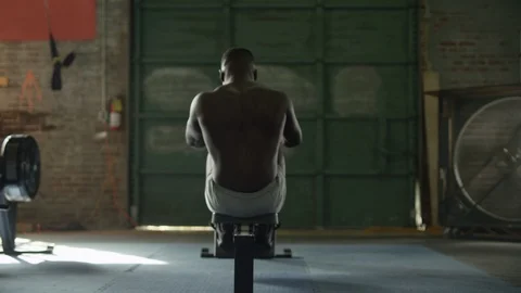 Wide shot of shirtless man using rowing ... | Stock Video | Pond5