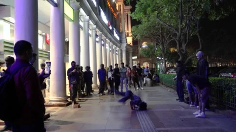 Wide shot showing busker doing hip hop dance with spins and handstands on the Stock Footage 149414988