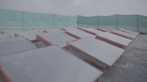 Wide shot of solar drying racks in an outdoor enclosure Stock-Footage 327442231
