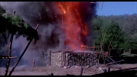 Wide shot of stone cabin exploding in rural setting, 1970s 库存影片 260259076