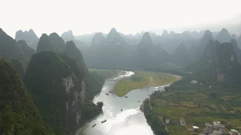 Wide shot of sugar loaf with rivers between the mountains, in Yangshuo, China Stock Footage 232188751