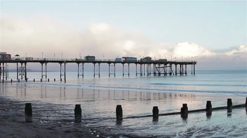Wide Shot Sunset Light Reflecting Off Teignmouth Beach and Pier 動画素材 46360733