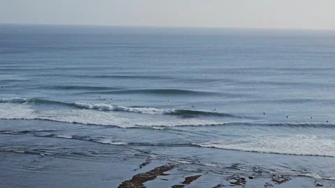 Wide Shot of Surfers Catching Waves at Uluwatu, Bali Stock Footage 340322527