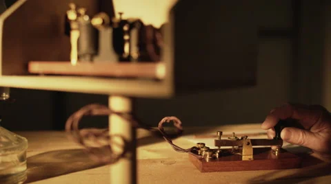 Wide shot of telegrapher using a morse code key 4k 動画素材 66736389