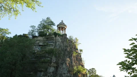 Wide Shot of Temple de la Sibylle on High Rocky Cliff at Parc des Buttes-Chaumon Stock Footage 338382992