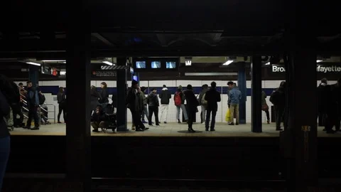 Wide shot of a train approaching a New York subway platform Stock Footage 98665824