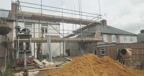 Wide shot of two construction workers on a building site Stock Footage 246381359