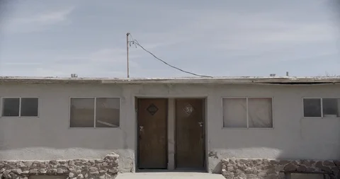 Wide Shot of Two Doors of an Abandoned Motel - Tilt Down Stock Footage 89942873