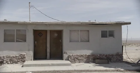 Wide Shot of Two Doors of an Abandoned Motel - Pan Across Stock Footage 89942877