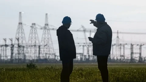 Wide shot of two engineers in hard hat discussing something talking on a Video stock 75631795