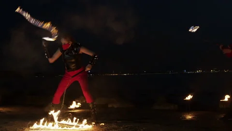 Wide shot of two fire artists performing their show Stock Footage 144745351