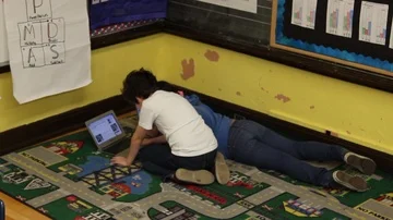 Wide Shot Of Two Students Discussion Work On Floor With Computer Stock Footage 85705550