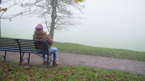 Wide Shot Upset Elderly Man Alone on Bench Stock Footage 150975915