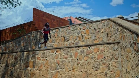 Wide shot view of acrobatic running on stairs in city park Stock Footage 117688301