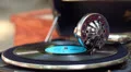 Wide shot of vintage gramophone playing music in city park HD Footage