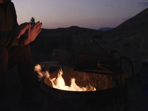 Wide shot of warming Hands next to Fire Stock Footage 71626504