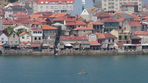 A wide shot of the waterfront in Combarro, Spain, featuring traditional stone Stock Footage 346718882