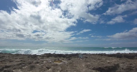 Wide Shot of Waves Rolling in Behind Volcanic Rock in Hawaii Stock Footage 104431700