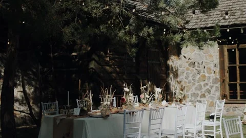 Wide shot of wedding table served outdoor and decorated with autumn earth Stock Footage 266800621