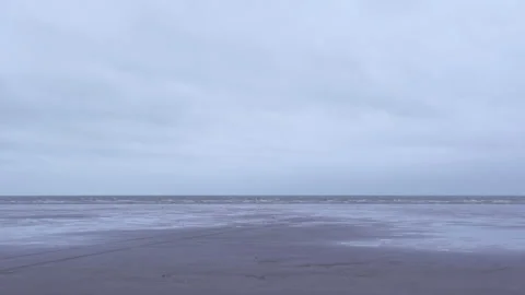 Wide Shot of a Welsh Beach on an Overcast Day during a Low Tide Stock Footage 293087329