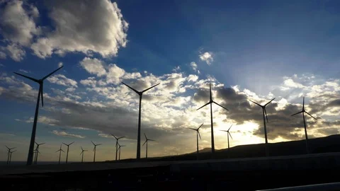 Wide shot of a wind generator farm at sunset. Stock Footage 97463985